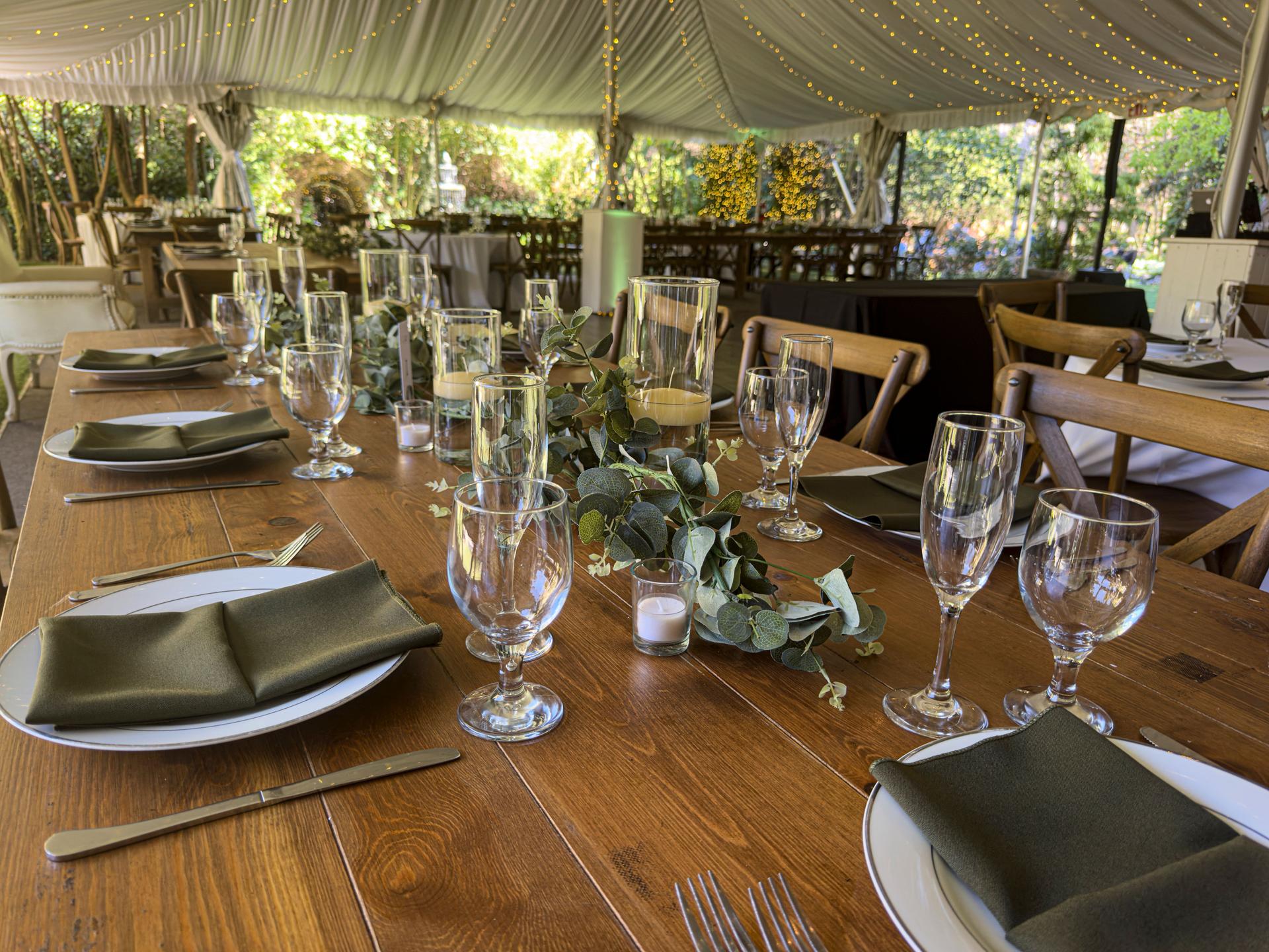 Elegant Empty Wedding Reception Table Settings in Rustic Tent Venue