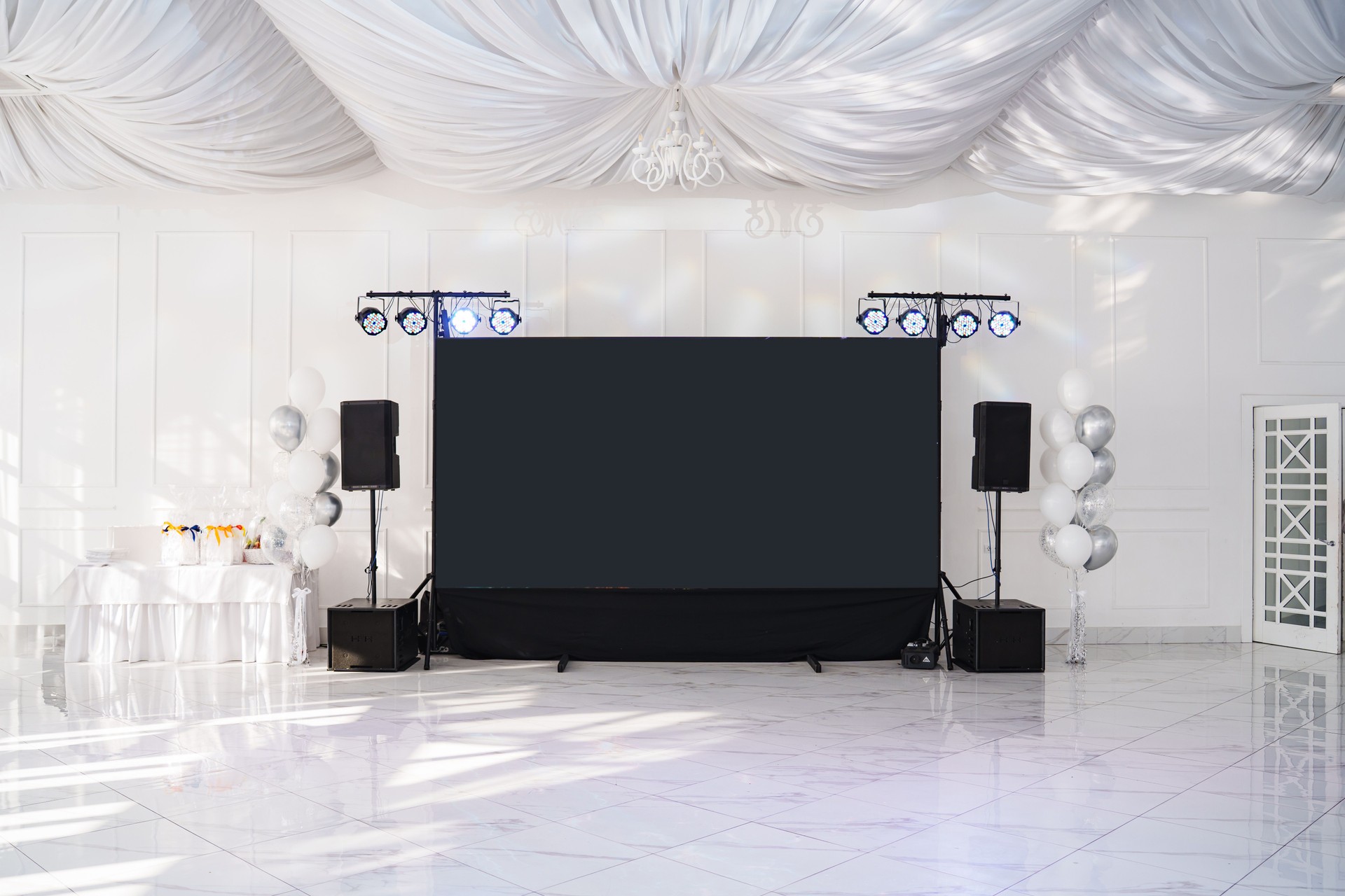 Elegant event space with a large screen and decorative lighting setup